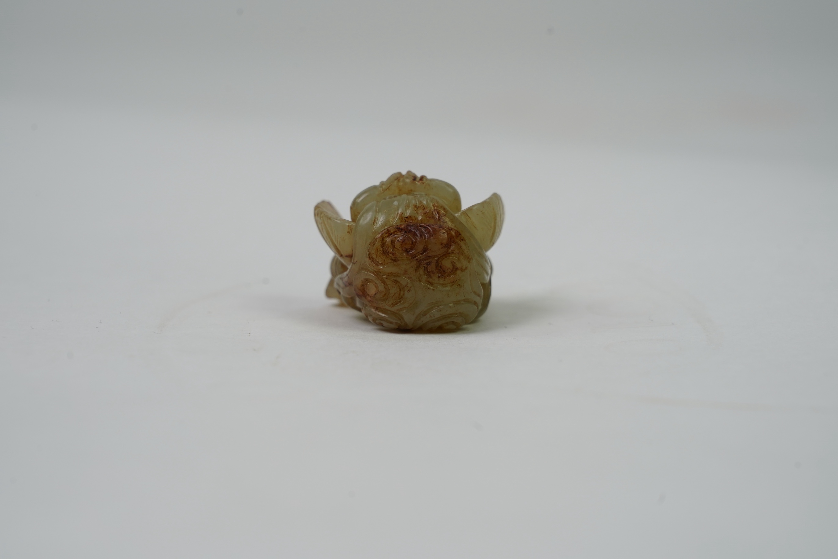 A Chinese archaistic celadon and russet jade figure a winged female immortal bird